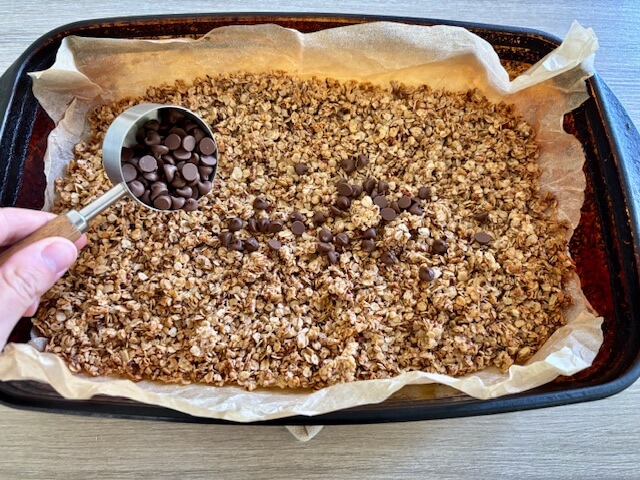Adding chocolate chips to the granola.
