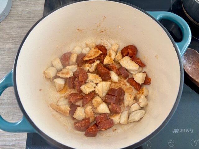 Chorizo added to sealed chicken in pan
