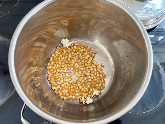 Adding the popcorn kernels to the oil