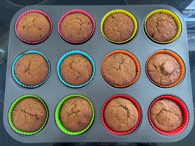 12 Banana chocolate chip muffins that have been cooked in the oven.