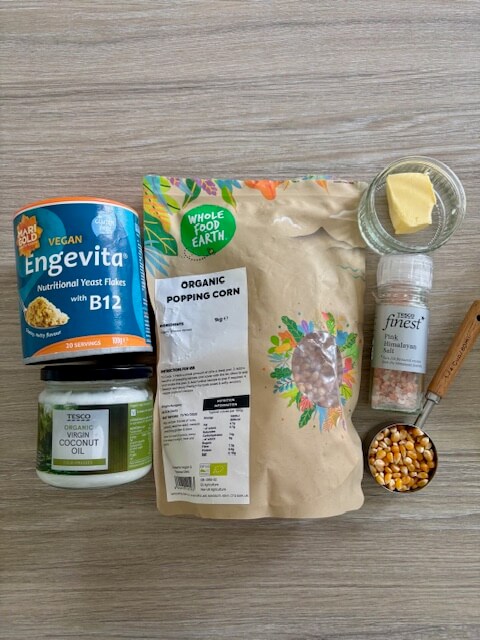 Homemade Popcorn ingredients - nutritional yeast, coconut oil, popcorn kernels, butter and salt