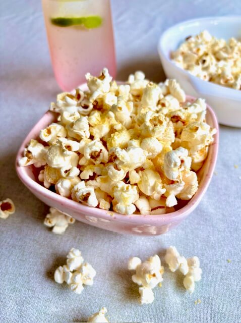 Finished homemade popcorn in a pink serving bowl