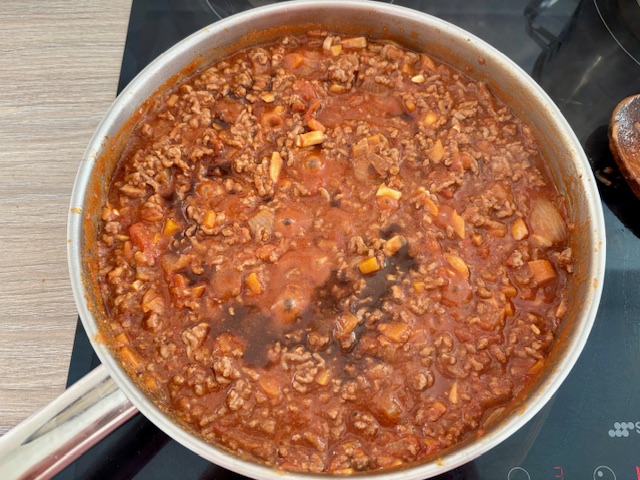 Adding the Worcestershire sauce to the Bolognese sauce