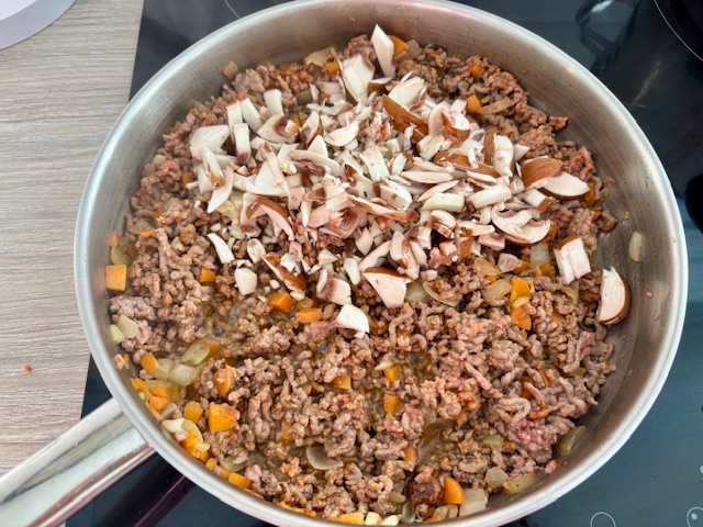 Adding the mushrooms and garlic.