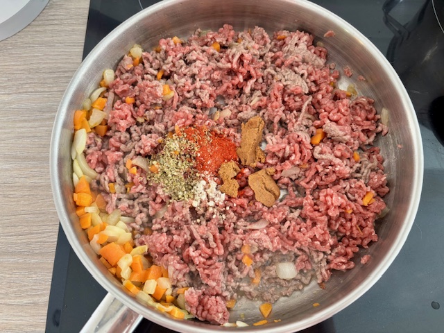 Adding the spices to the pan.