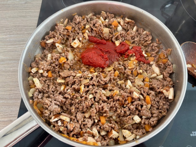 Adding the tomato puree