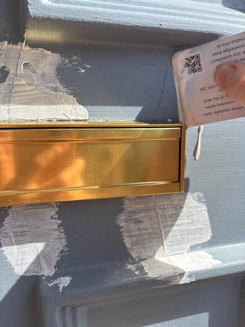 Applying surface filler to the cracks in the door