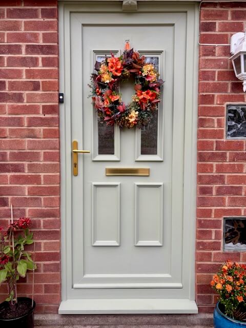 After shot of front door painted in Wise Old Sage (a green grey colour)