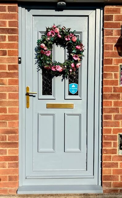 Before photo of front door painted a blue grey colour