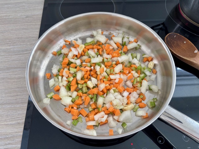 Onions, carrots and celery in frying pan.