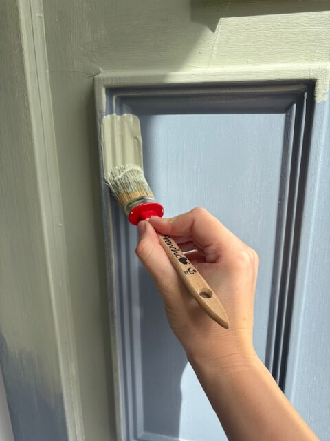 Applying paint to the front door