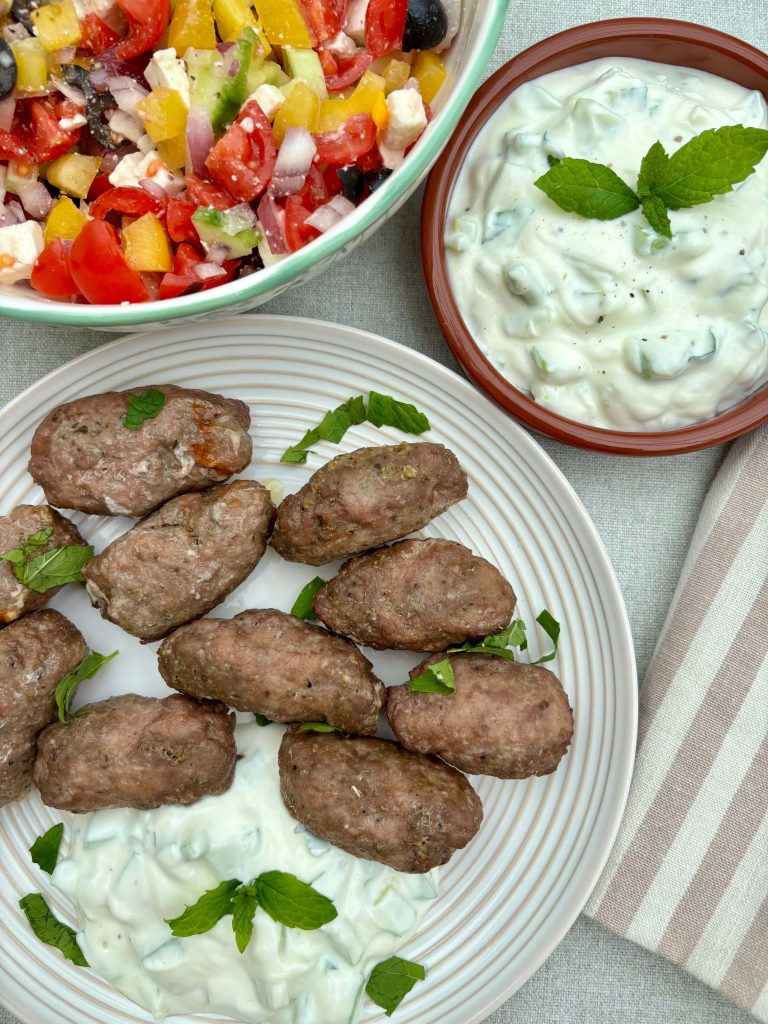 Lamb Koftas and Tzatziki Yogurt Dip next to Greek side salad